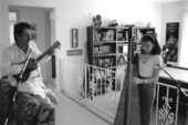 Ana Maria DeArmas playing the Venezuelan harp as Jesus Rodriguez accompanies on cuatro- Naples, Florida