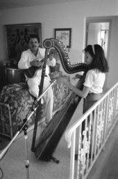 Ana Maria DeArmas playing the Venezuelan harp as Jesus Rodriguez accompanies on cuatro- Naples, Florida