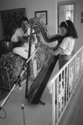 Ana Maria DeArmas playing the Venezuelan harp as Jesus Rodriguez accompanies on cuatro- Naples, Florida