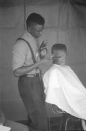 Vaughan McCall cutting and styling hair at the Zora Neale Hurston Festival- Eatonville, Florida.