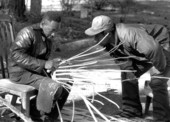 Apprentice Michael Steen watches Alphonso Jennings working on a white oak basket - Lamont, Florida