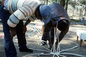 Apprentice Michael Steen (L) watches teacher Alphonso Jennings as he lays out the pattern of a white oak basket - Lamont, Florida