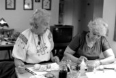 Ola Kryway (L) looks on as apprentice Mary Martin decorates Easter eggs with the Ukrainian pysanky technique - Titusville, Florida.