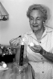 Ola Kryway decorating an Easter egg by applying melted beeswax with a kystka - Titusville, Florida.