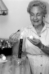 Ola Kryway decorating an Easter egg by applying melted beeswax with a kystka - Titusville, Florida.