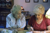 Ola Kryway (L) looks on as apprentice Mary Martin decorates an Easter egg using the Ukrainian pysanky technique - Titusville, Florida.