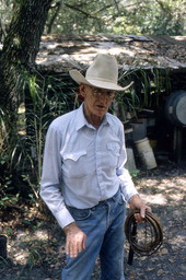 Cow whip maker George "Junior" Mills holding whip - Okeechobee, Florida.