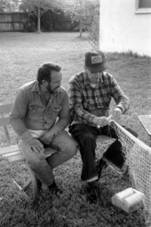 Apprentice Reginald Reis observes while master netmaker Max Dooley works on a net - Lakeland, Florida.