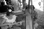 Jesus Rodriguez playing Venezuelan harp and his apprentice Ana Maria de Armas playing cuatro at the 1988 Florida Folk Festival - White Springs, Florida