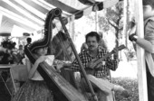 Jesus Rodriguez playing cuatro and his apprentice Ana Maria de Armas playing Venezuelan harp at the 1988 Florida Folk Festival - White Springs, Florida