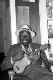 Portrait of William "Washboard Bill" Cooke with his ukulele