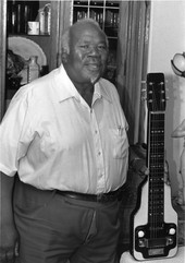 Gospel guitarist Willie Eason posing with his lap steel guitar in Florida.