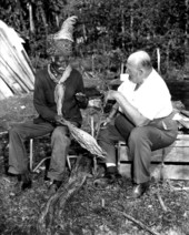 Billy Bowlegs III, with Albert DeVane watching, "shade cures" tobacco