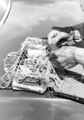 Close-up view showing Valley Hill working on one of his fish castnets.