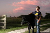 Kaley Dees with the family cow in Okeechobee, Florida.