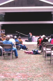 Jean Ritchie playing an autoharp while the crowd listens - White Springs, Florida