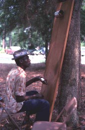 Moses Williams playing the diddley bow at the 1978 Florida Folk Festival