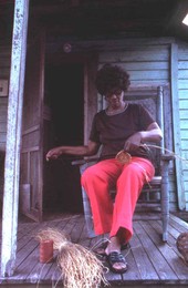 African American woman making a sweetgrass basket.