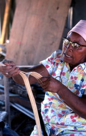 Basket maker Lucreaty Clark tearing white oak into strips