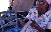 Basket maker Lucreaty Clark tearing white oak into strips