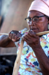 Basket maker Lucreaty Clark tearing white oak into strips
