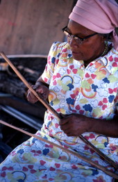 Lucreaty Clark preparing strips of white oak for basket making