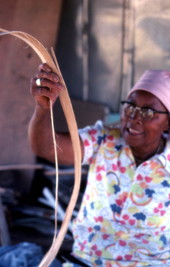 Basket maker Lucreaty Clark cutting white oak into strips