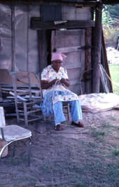 Basket maker Lucreaty Clark cutting white oak into strips