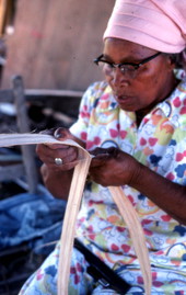 Basket maker Lucreaty Clark cutting white oak into strips