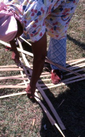 Basket maker Lucreaty Clark laying out strips of white oak