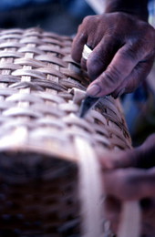 Close-up view of Lucreaty Clark making a white oak basket