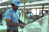 Billy Burbank III in the middle of making a fishing net - Fernandina Beach, Florida