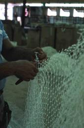 Billy Burbank III in process of making a fishing net - Fernandina Beach, Florida