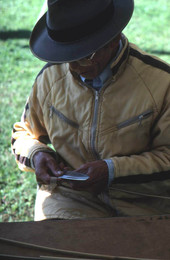 Tuyen Pham whittling down pieces of wood to make a rice basket- Pensacola, Florida.