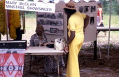 Mary McClain at her booth, talking to a woman - White Springs, Florida