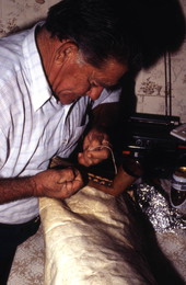 Nikitas Tsimouris preparing to play a tsambouna - Tarpon Springs, Florida