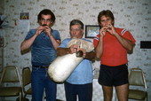 Nikitas Tsimouris playing a tsambouna while George Pilatos (L) and Antonios Tsimouris (R) accompany on practice chanters - Tarpon Springs, Florida