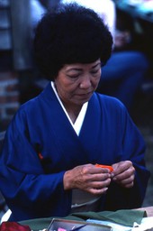 Kazuko Law making origami at the Great Gulf Coast Arts Festival- Pensacola, Florida.