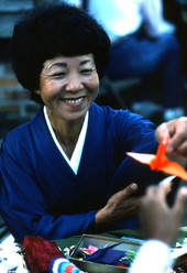 Kazuko Law handing out origami at the Great Gulf Coast Arts Festival- Pensacola, Florida.