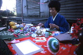 Kazuko Law making origami at the Great Gulf Coast Arts Festival- Pensacola, Florida.
