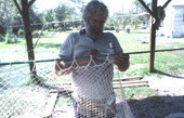 Costa Buzier assembles a shrimp trawl net - Apalachicola, Florida.