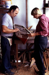Bobby Shiver shows Nancy Nusz a boat model made by his son - Eastpoint, Florida