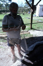 Costa Buzier ties net webbing of shrimp trawl - Apalachicola, Florida.