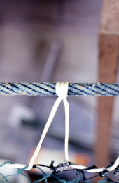 Detailed view of a fishing net being knitted by Rickey Doublerly - Jacksonville, Florida.