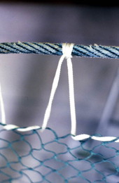 Detailed view of a fishing net being knitted by Rickey Doublerly - Jacksonville, Florida.