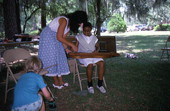 Eugenia Fitchen teaching a girl old-time dulcimer music at the Children's Activity Area- White Springs, Florida