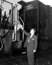 Acting Governor Charley E. Johns shaking the hand of train engineer - Starke, Florida