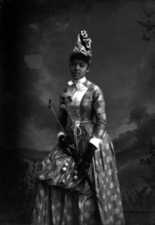 Nellie Franklin, holding a parasol.