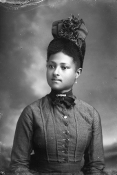 Young woman wearing fancy hat.