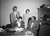 Robert E. Lee senior Hoyt Axton signing football scholarship for Oklahoma A&M College as parents look on.